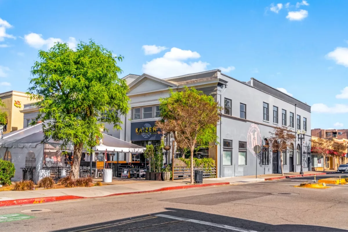 Downtown Santa Ana street with shops and tented seating area