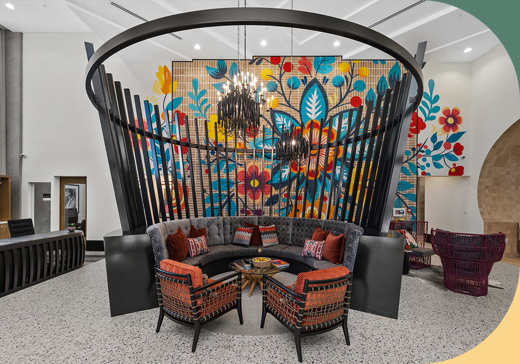Rafferty lobby with chairs and couches, large wooden sculpture, and colorful floral mural on the wall