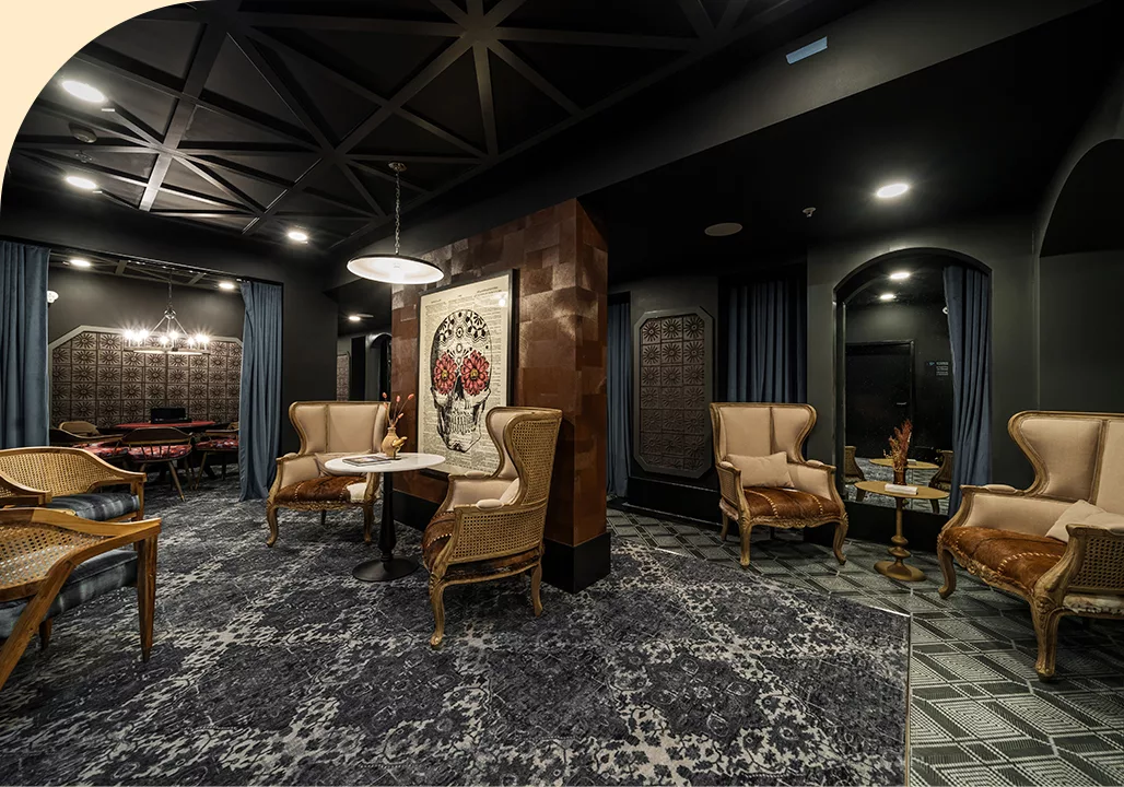 Speakeasy room with dark, lush furniture and fixtures